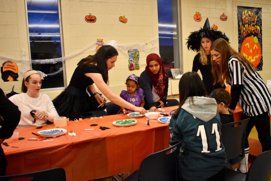 The YEA Club helping the preschoolers with Halloween themed crafts. 