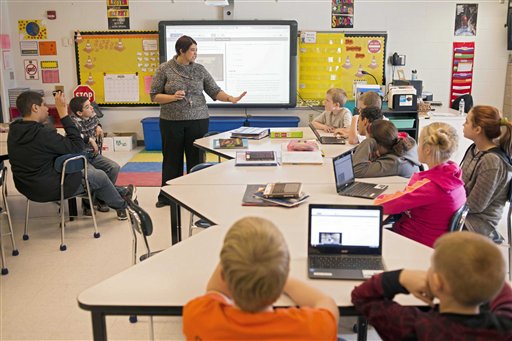 In this photo taken Feb. 12, 2015, sixth grade teacher Carrie Young guides her students through an exercise on their laptops as practice for the the Common Core State Standards Test in her classroom at Morgan Elementary School South in Stockport, Ohio. On Tuesday, Ohio becomes the first state to administer one of two tests in English language arts and math based on the Common Core standards developed by two separate groups of states. By the end of the year, about 12 million children in 28 states and the District of Columbia will take exams that are expected to be harder than traditional spring standardized state tests they replace. In some states, theyll require hours of additional testing time students will have to do more than just fill in the bubble. The goal is to test students on critical thinking skills, requiring them to describe their reasoning and solve problems. (AP Photo/Ty Wright)