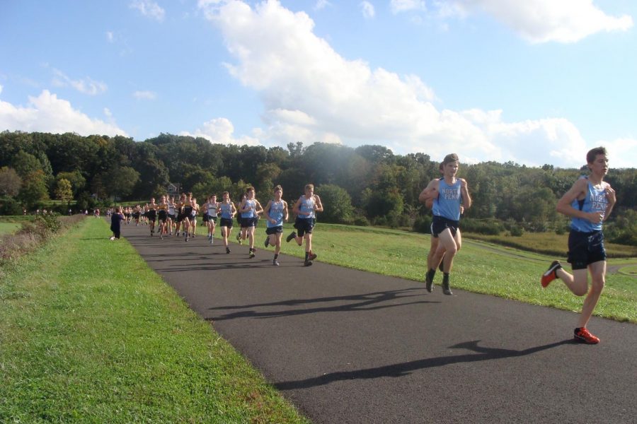 Junior Matt Long leads a pack of blue within the opening mile of the race