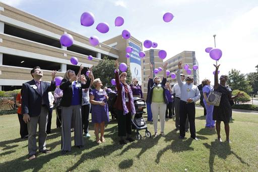 Over 100 balloons bearing names of loved ones living with Alzheimers disease or any form of dementia are released by family members, friends or staff at the University of Mississippi Medical Center in Jackson, Miss., in recognition of World Alzheimers Day, Wednesday, Sept. 21, 2016. The medical school partnered with several other Alzheimer and dementia support groups statewide to paint it purple event, a state exclusive event of releasing purple biodegradable balloons. (AP Photo/Rogelio V. Solis)