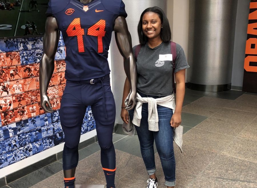 Cydney Lee, graduate of the class of 2016, photographed next to a football mannequin at the Locolano-Petty Football Complex. 