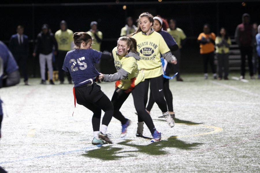 Junior Bree Hines reaches for Senior Alexa Sprangos flag. 