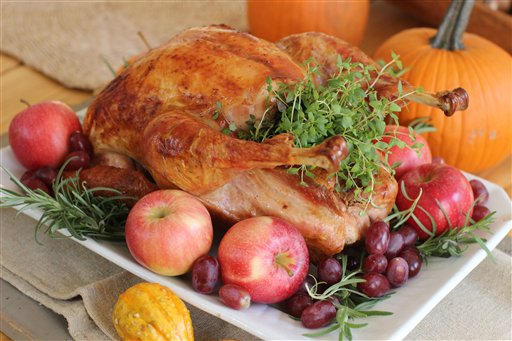 This Oct. 12, 2015, photo shows a roasted Thanksgiving turkey in Concord, N.H. Regardless of how you cook the turkey, experts say to make sure you let it sit, undisturbed, on a cutting board or platter for at least 30 minutes before carving. This allows the bird to finish cooking more gently and reabsorb all of its juices, producing moist meat. (AP Photo/Matthew Mead)