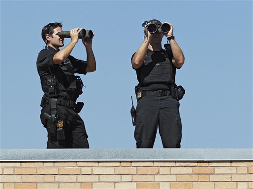 SWAT team members watch the crowd as President Barack Obama talks about his jobs bill at Lincoln High School in Denver, Tuesday, Sept. 27, 2011. (AP Photo/Ed Andrieski)