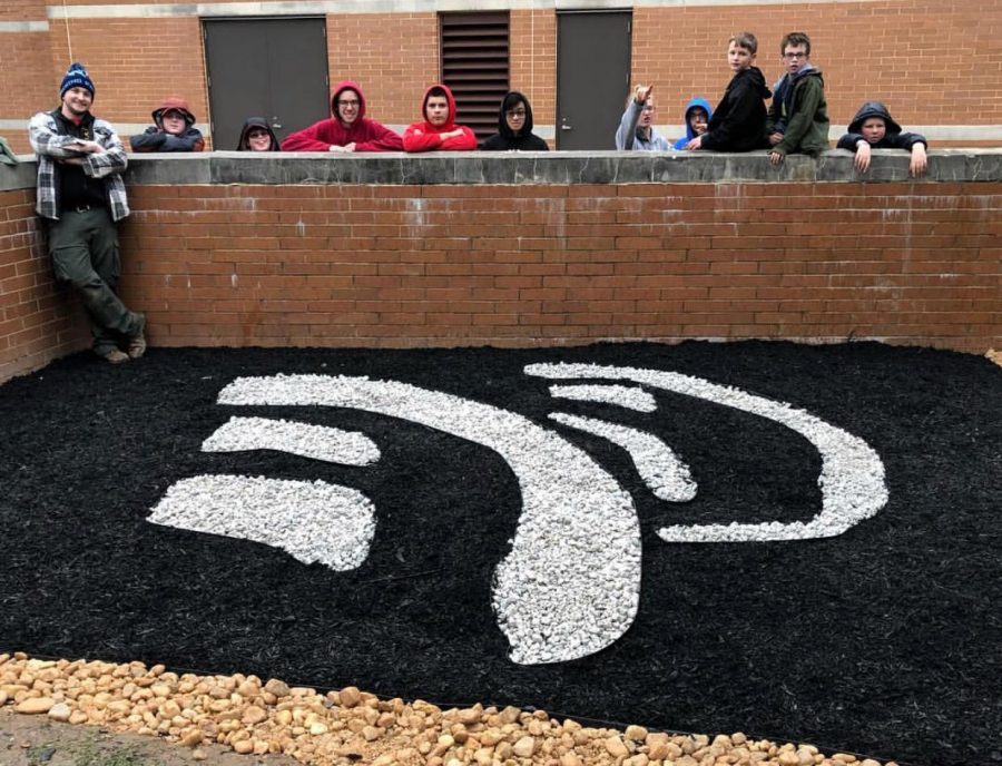 Thomas Lloyd and his crew pose for picture of a newly landscaped NP music logo outside of North Penn High School. Lloyd created this space as part of his Eagle Scout project. 