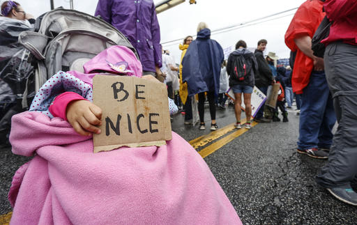 A young child in a stroller holds a sign at the Womens March on Saturday, Jan. 21, 2017, in Atlanta. The rally and march drew thousands of attendees, including , U.S. Rep. John Lewis, who had been at odds with president Donald Trump leading up to the inauguration. (AP Photo/Ron Harris)