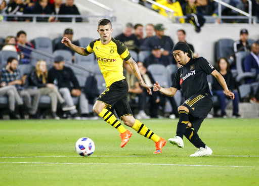 Los Angeles FC midfielder Lee Nguyen (24) and Borussia Dortmund midfielder Christian Pulisic (22) in actions during an international friendly soccer game between Los Angeles FC and Borussia Dortmund in Los Angeles, Tuesday, May 22, 2018. The game ended in a 1-1 draw. (AP Photo/Ringo H.W. Chiu)