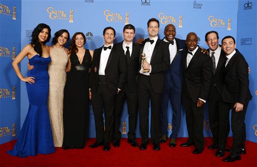 From left, Stephanie Beatriz, Melissa Fumero, Chelsea Peretti, Andy Samberg, Michael Schur, Dan Goor, Terry Crews, Andre Braugher, David Miner and Joe Lo Truglio pose in the press room with the award for best television series - comedy or musical for Brooklyn Nine - Nine at the 71st annual Golden Globe Awards at the Beverly Hilton Hotel on Sunday, Jan. 12, 2014, in Beverly Hills, Calif. (Photo by Jordan Strauss/Invision/AP)