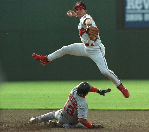 Cleveland Indians shortstop Omar Vizquel jumps to avoid Boston Red Soxs John Valentin after forcing him out at second base on the first half of a double play during the first inning in Cleveland, Thursday, June 20, 1996. Red Soxs Mo Vaughn was out at first. (AP Photo/Phil Long)