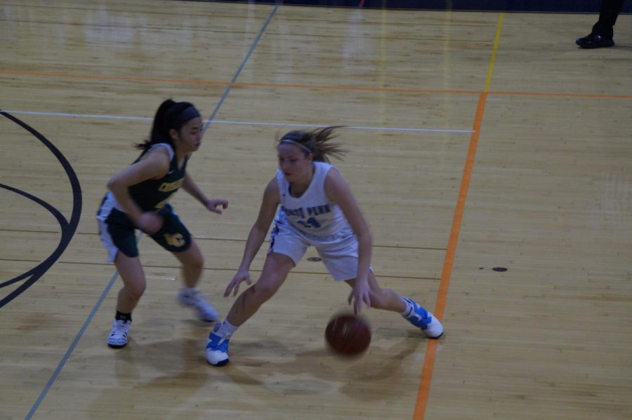 Sophomore Alli Lindsay is defended by Maile Erwin.  Lindsay had 24 points.