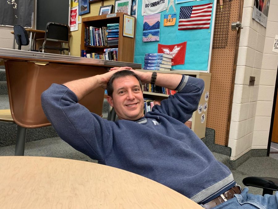 Mr. Young lounging in his classroom, C039.