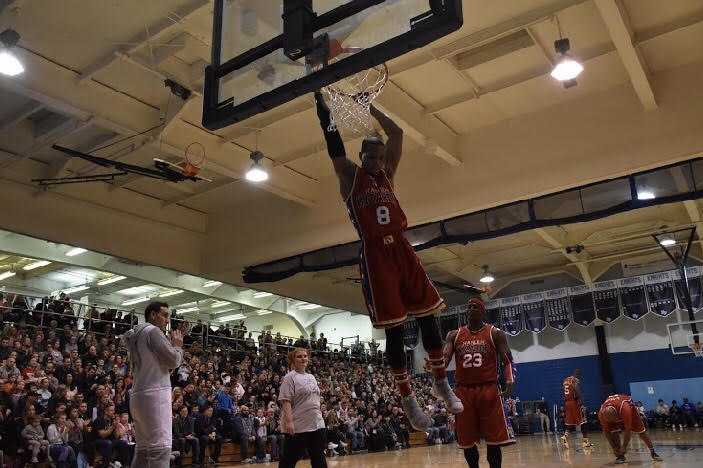 Livewire hangs on to the basket after a dunk. 
