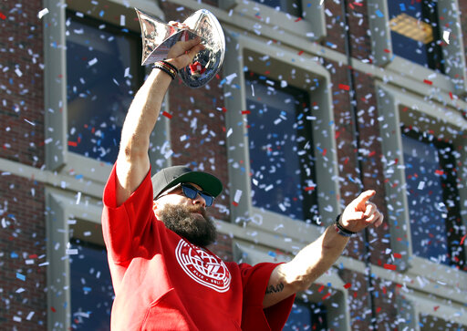 New England Patriots' Julian Edelman holds up a trophy to fans during their victory parade through downtown Boston, Tuesday, Feb. 5, 2019, to celebrate their win over the Los Angeles Rams in Sunday's NFL Super Bowl 53 football game in Atlanta. Edelman was the MVP of the game. The Patriots have won six Super Bowl championships. (AP Photo/Elise Amendola)