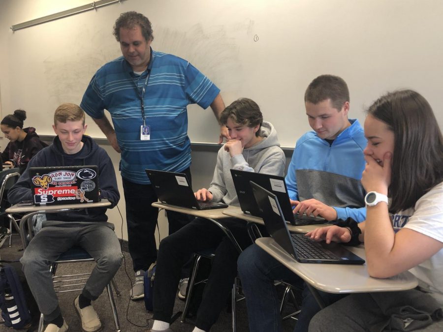 Dr. Dave Hall works with a group of students during a recent class period at NPHS.