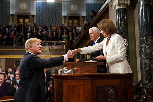 President Donald Trump shakes hands with House Speaker Nancy Pelosi as Vice President Mike Pence looks on, as he arrives in the House chamber before giving his State of the Union address to a joint session of Congress, Tuesday, Feb. 5, 2019 at the Capitol in Washington. (Doug Mills/The New York Times via AP, Pool)