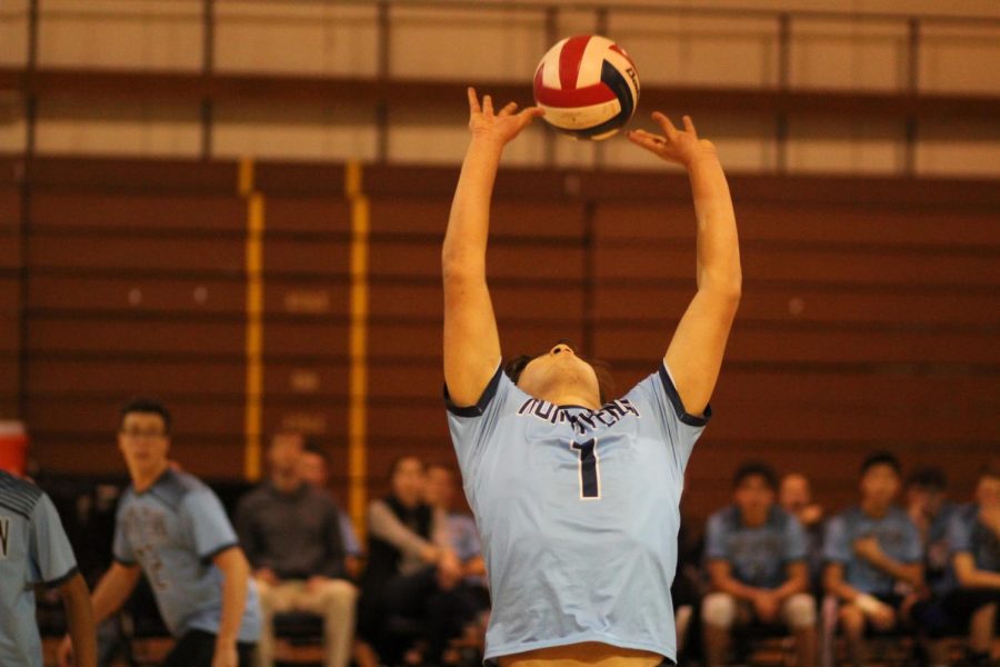 Junior Ryan Stewart sets the ball up for a spike.