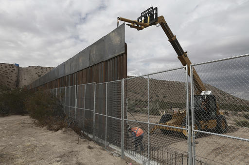 FILE - In this Nov. 10, 2016, file photo, workers continue work raising a taller fence in the Mexico-US border area separating the towns of Anapra, Mexico and Sunland Park, N.M. U.S. Customs and Border Protection said Friday, Feb. 24, 2017, that it plans to start awarding contracts by mid-April for President Donald Trumps proposed border wall with Mexico, signaling that he is aggressively pursuing plans to erect a great wall along the 2,000-mile border. (AP Photo/Christian Torres, File)