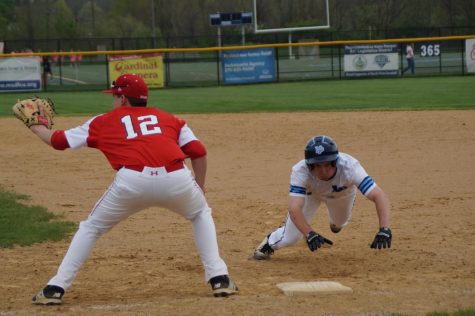 3B Connor Ertel dives back in to first as P Luke Taylor attempts a pickoff.