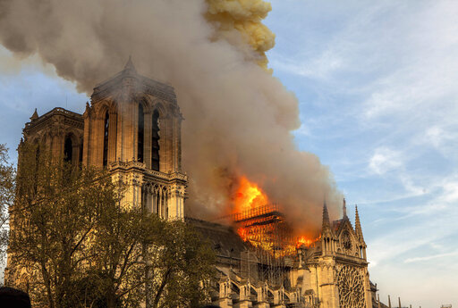 This photo taken on Monday April 15, 2019 shows Notre Dame cathedral burning in Paris. Firefighters declared success Tuesday April 16, 2019 morning in an over 12-hour battle to extinguish an inferno engulfing Paris iconic Notre Dame cathedral that claimed its spire and roof, but spared its bell towers. (AP Photo/Vanessa Pena)