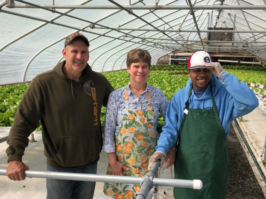 Landes with a student at GreenWorks Farm, a site she takes students to as a job coach.