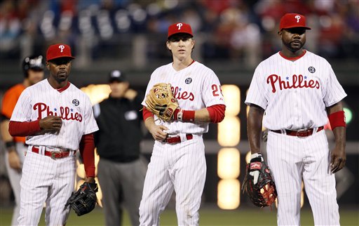 Philadelphia Phillies from th eleft, Jimmy Rollins, Chase Utley, and Ryan Howard during  a baseball game against the Miami Marlins, Friday, April 11, 2014, in Philadelphia. (AP Photo/Tom Mihalek)