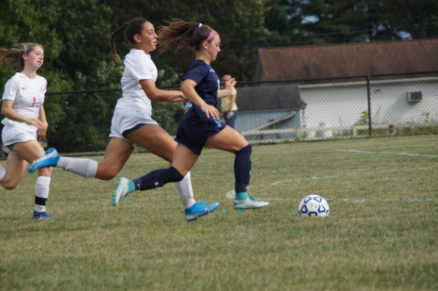 Emily Varilla dribbles past the Redskins defense to score a goal.
