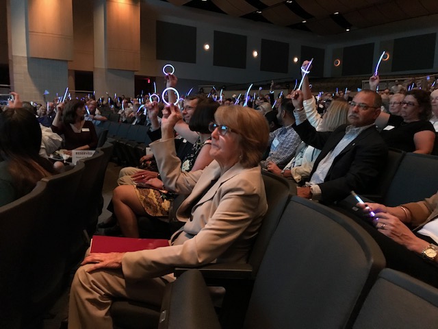 Prior to former NFL quarterback Ryan Leafs speech, attendees of the Penn Foundations annual fundraiser at Pennridge High School lift colorful glowsticks. Purple represents recovery, and white represents peace.