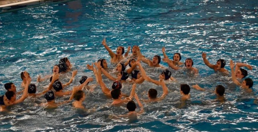 The boys water polo team celebrates their state title.