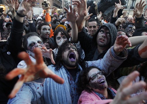 People dressed and made up as Zombies react, during the annual Zombie march, in Madrid, Saturday Feb. 27, 2010. The zombie march is a homage to the Zombie film genre and to U.S. director George A. Romero, famous for his Zombie horror movies. (AP Photo/Paul White)