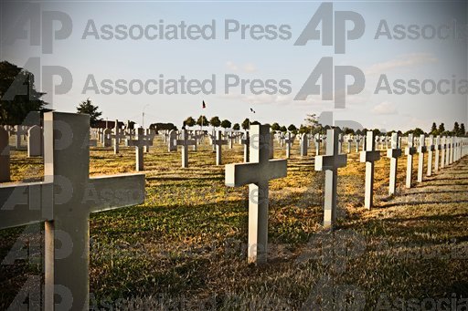 Unmarked cross headstones in a graveyard.