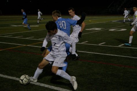 North Penns Ryan Mindick and La Salles James Crawford, battle for possesion of the ball near midfield.