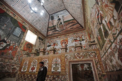 A groom waits for the bride before their wedding at the Sistine Chapel of Los Andes in Curahuara de Carangas, Oruro department, 260 km. (160 miles) south from La Paz, Bolivia, Saturday, Dec. 8, 2012.  Although a far cry from the original Sistine Chapel at the Vatican,  this small church, built in 1608 to evangelize indigenous Bolivians into the Roman Catholic faith, attracts both the faithful and tourists and its a popular choice for special religious services. (AP Photo/Juan Karita)