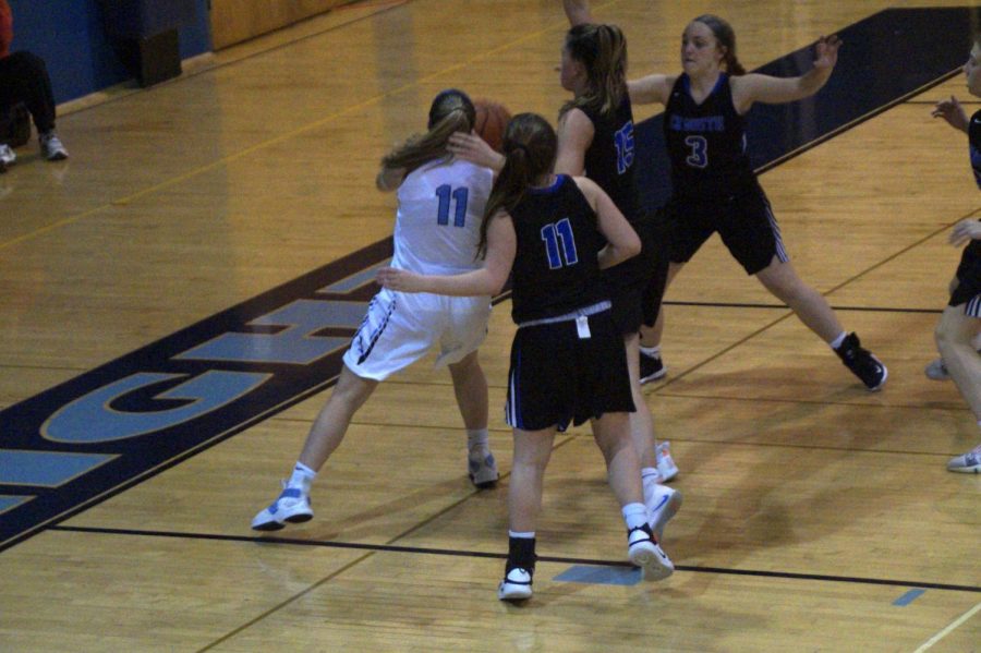 Alli Lindsay drives to the rim in the second half with several Titans nearby.