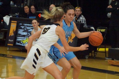 Pushing the Pace: Carley Adams dribbles with Olivia Irons guarding her in a fast-paced game between the Knights and Bucks.