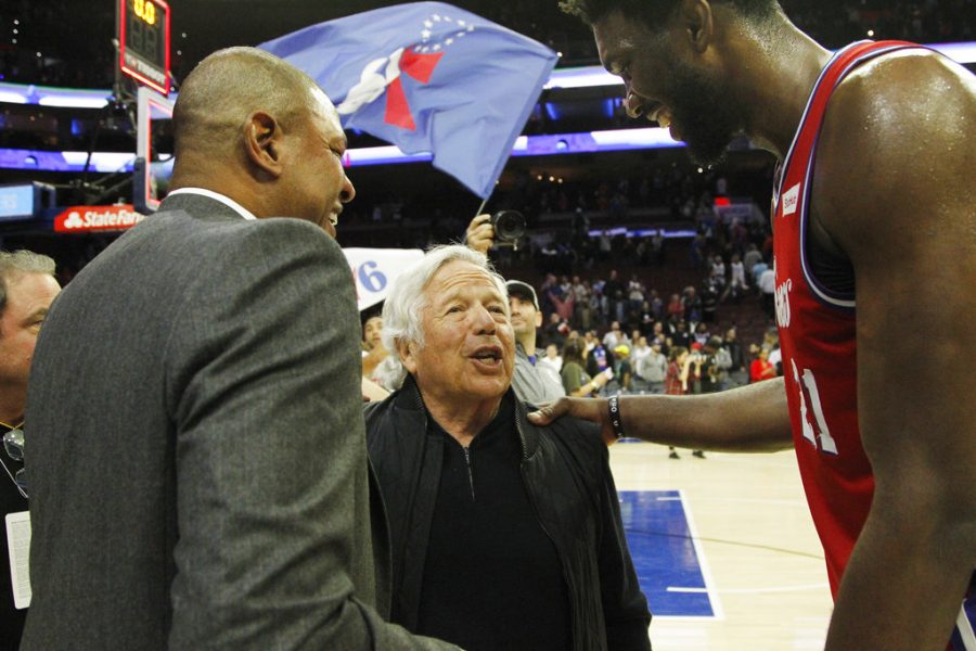 New England Patriots NFL football team CEO Robert Kraft, center, and Los Angeles Clippers coach Doc Rivers, left, talks with Philadelphia 76ers center Joel Embiid after an NBA basketball game against the Los Angeles Clippers, Thursday, Nov. 1, 2018, in Philadelphia. The 76ers won 122-113. (AP Photo/Laurence Kesterson)