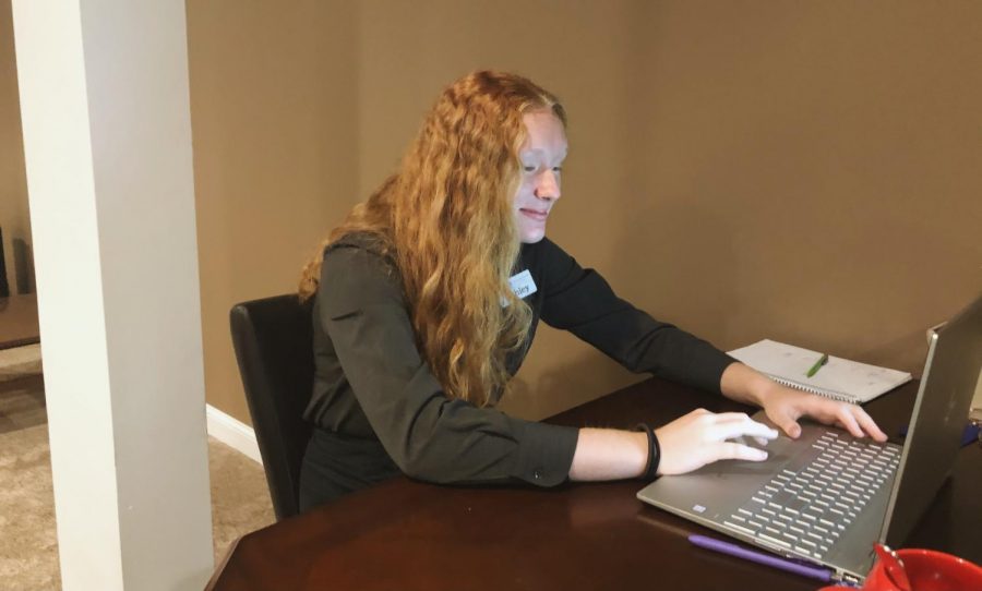 Junior Ashley Kitch in front of her computer screen participating in online school.