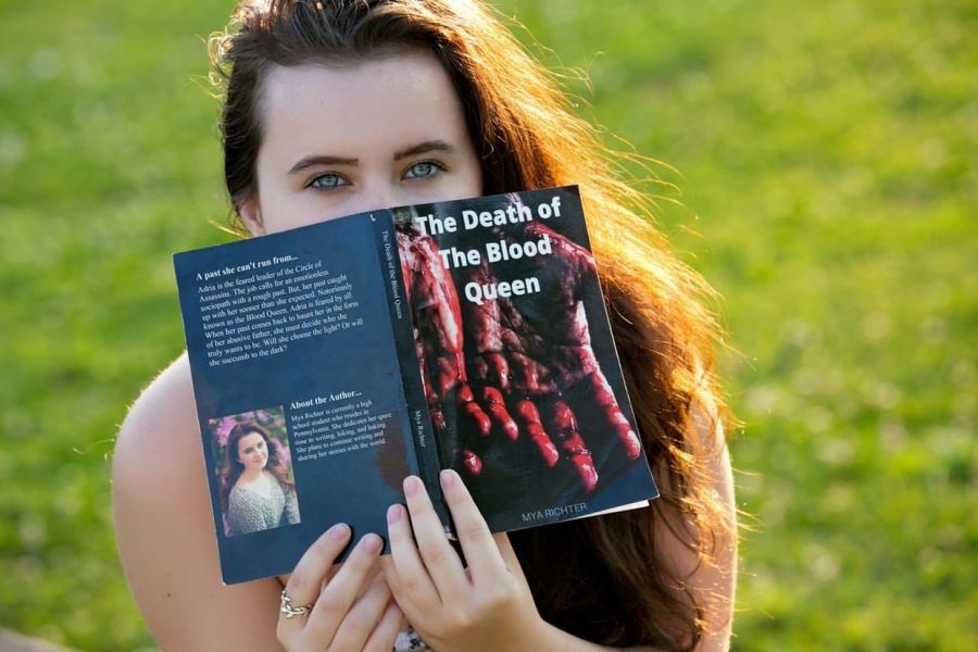 Mya+Richter+posing+with+her+first+published+book+The+Death+of+the+Blood+Queen.