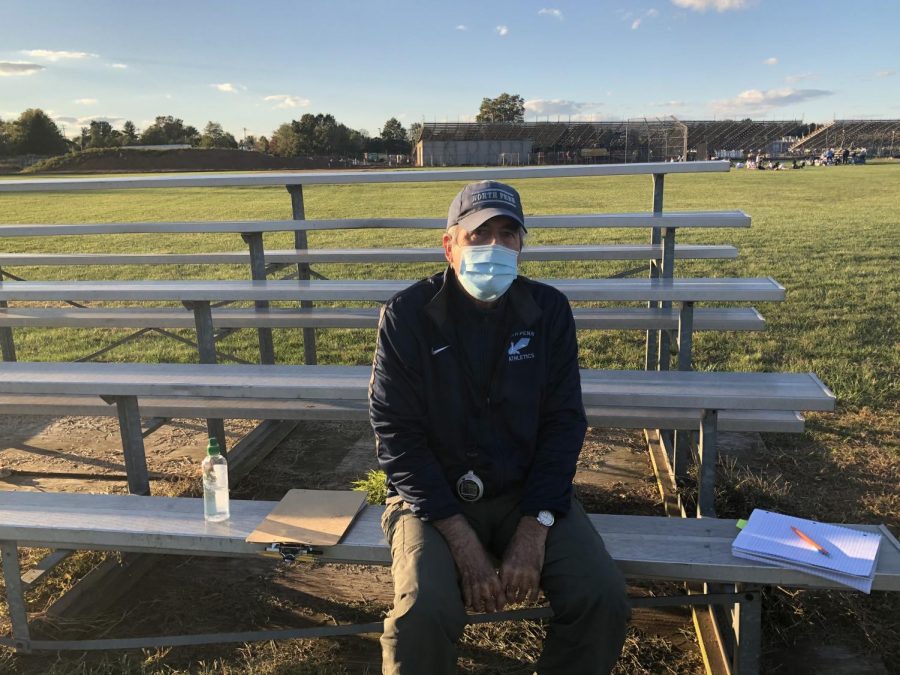 Coach Jim Crawford Jr sitting on the benches by the softball field after s Cross Country practice last week.  Jim Crawford, Jr has seen a lot in his years coaching at North Penn, and now hes coaching through a pandemic. 