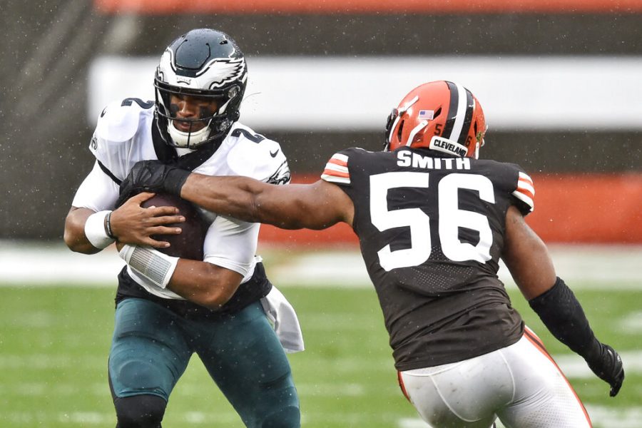 Philadelphia Eagles quarterback Jalen Hurts (2) rushes against Cleveland Browns outside linebacker Malcolm Smith (56) during the first half of an NFL football game, Sunday, Nov. 22, 2020, in Cleveland. (AP Photo/David Richard)