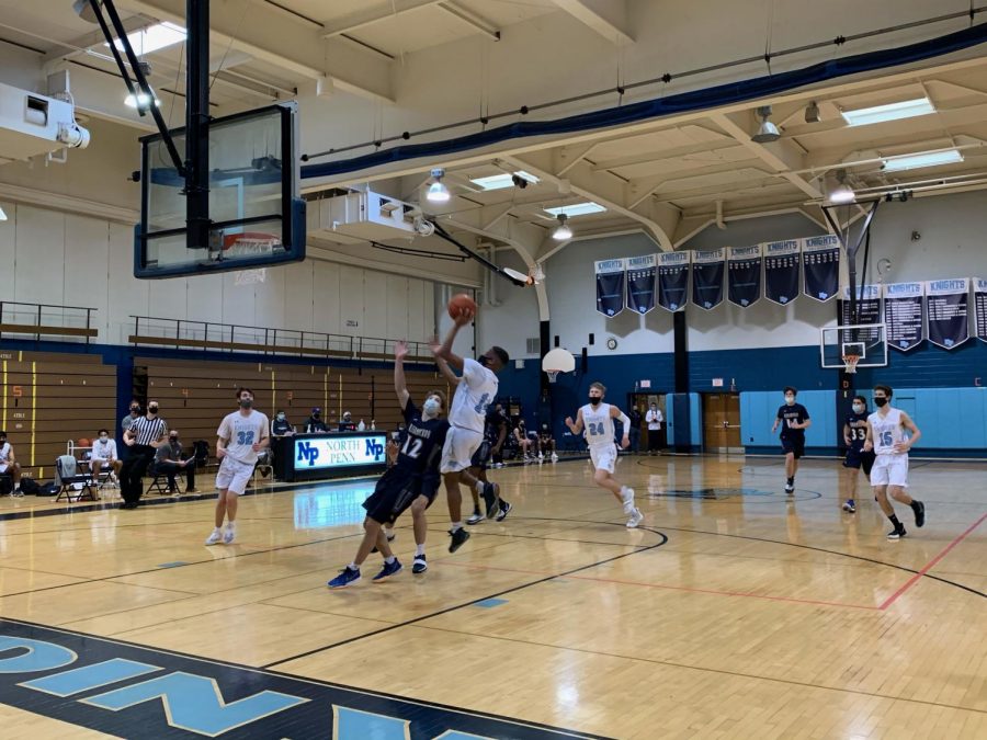 Junior Joey Larkins drives hard into the lane in transition for a quick 2.