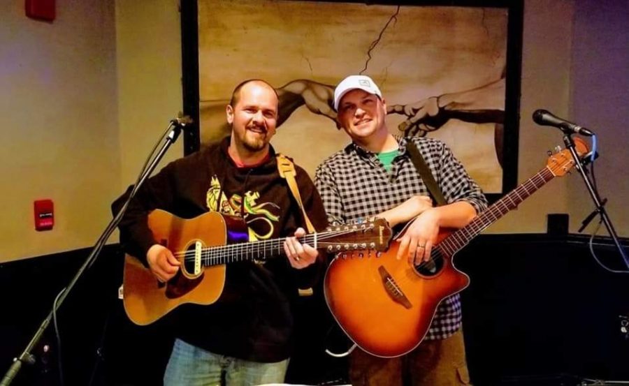 Gourley (Left) with his bandmate doing what they love together, playing the guitar.