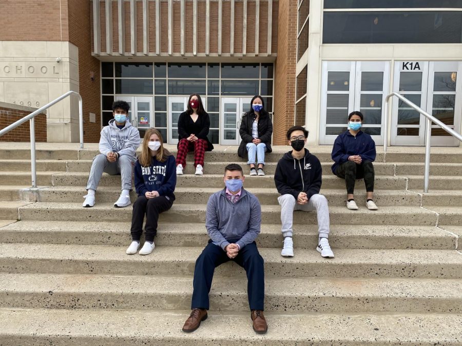 NHS Officers Ifrad Khan, Catherine Cavanaugh, Stacy Liang, Siddhi Date, Jadie Ferrell, and Gabriel Chang sit on the front steps of NPHS with their new Advisor, Sr. Alejandro Vidal