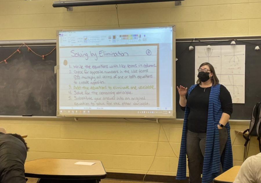 Mrs. Christina Boucher reviews todays lesson plan on solving by elimination at the start of her 7th period algebra class.
