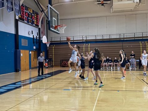 Liv Stone going for the layup and scoring two points for the Knights.