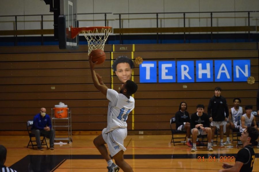 North Penn senior Joe Larkins scores a layup after stealing the ball from the Bucks during the boys senior night game.