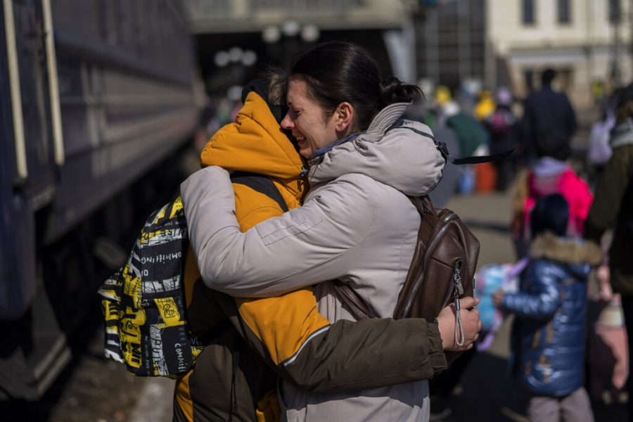 A mother embraces her son who escaped the besieged city of Mariupol and arrived at the train station in Lviv, western Ukraine on Sunday, March 20, 2022. (AP Photo/Bernat Armangue)