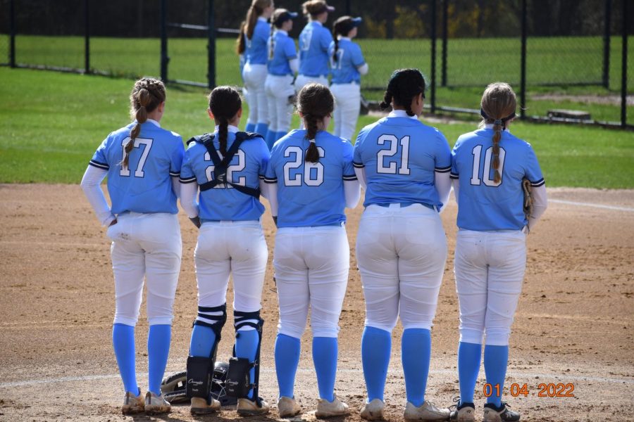 Knight Softball stands at the mound for the National Anthem