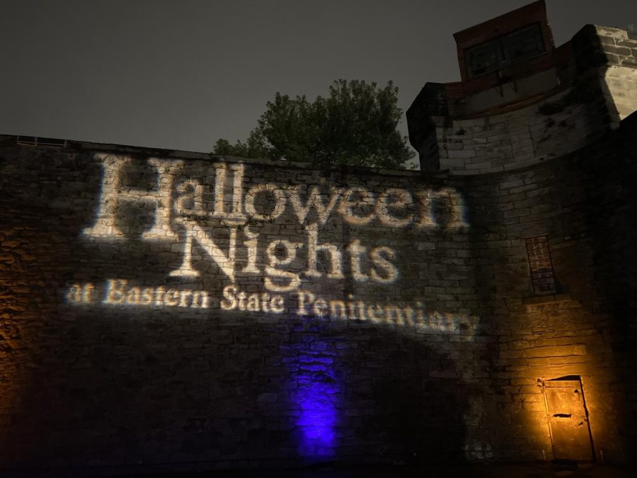 A projection of the new title on the rugged perimeter wall of Eastern State Penitentiary.