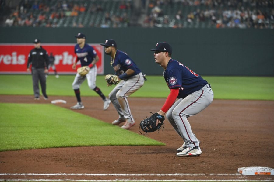 Minnesota Twins first baseman Jose Miranda, second baseman Luis Arraez and shortstop Carlos Correa (4) stand in a defensive shift during the fourth inning of a baseball game against the Baltimore Orioles , Wednesday, May 4, 2022, in Baltimore. (AP Photo/Tommy Gilligan)