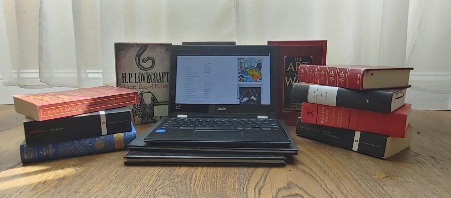 The Troubadour site is featured on a laptop, surrounded by various literary works.